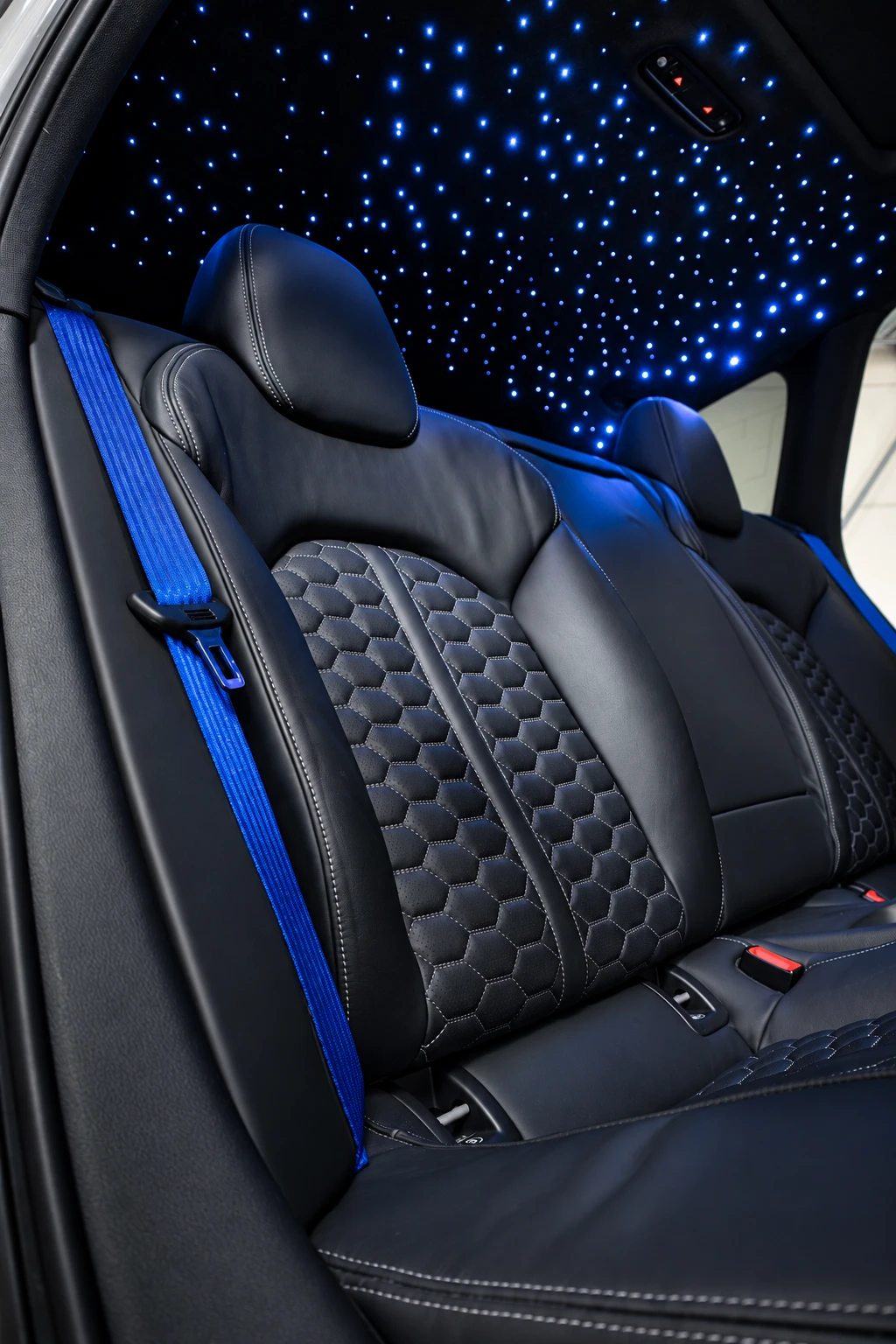 Blue fibre-optic stars above the rear seats of a luxury car