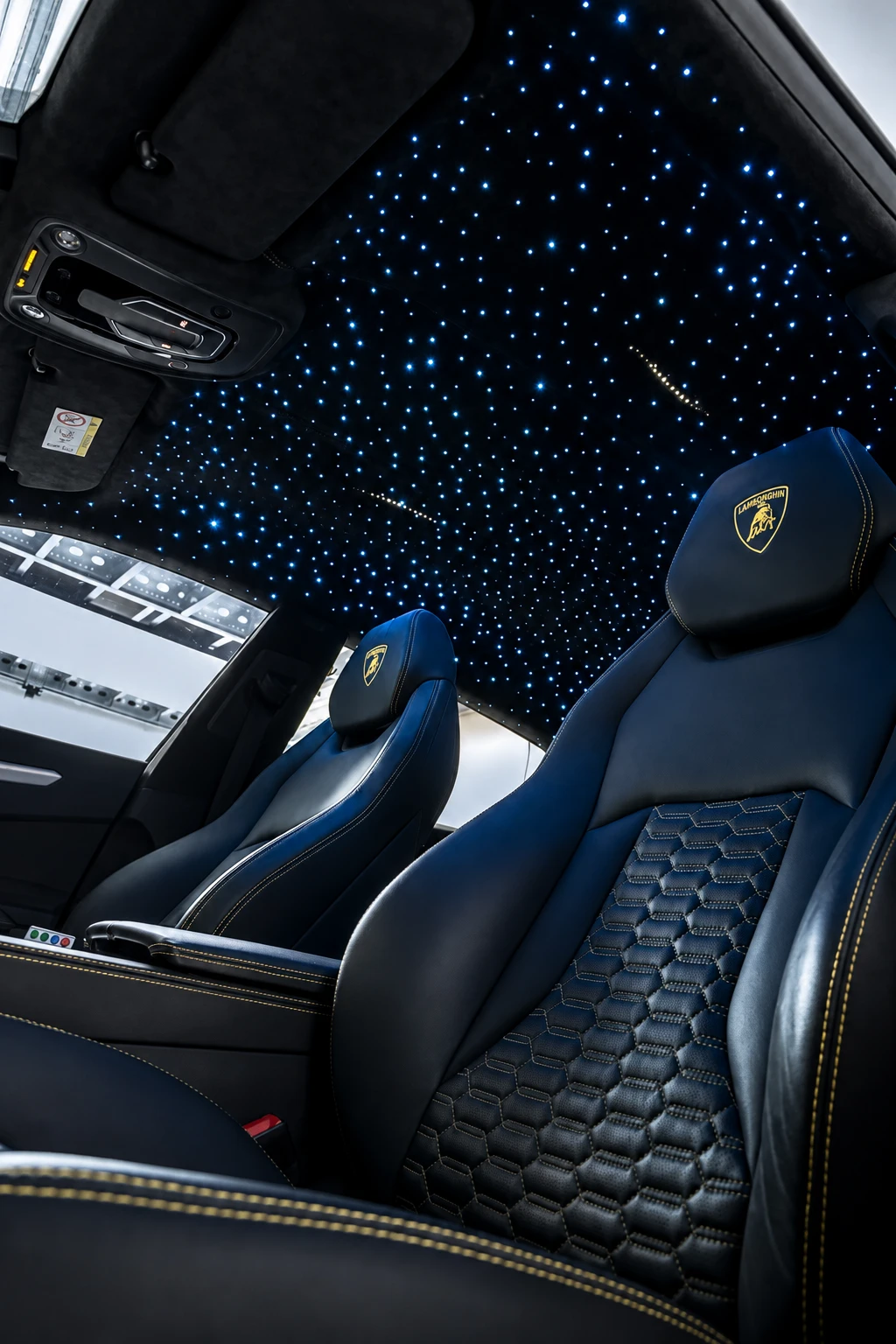 White stars in the black headliner of a Lamborghini Urus with black leather seats